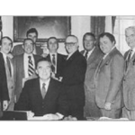 December 23, 1981 Governor Ed King (seated), signs Mass General Law 150E, which defines members of the Boston Police Detectives Benevolent Society as “Professional Employees.” Left to right: Attorney Mike Muse, The late Dan Mahoney, First President BPDBS, State Representative Jim Brett, Dorchester, State Representative Tom Finneran, Mattapan, The late Representative Kevin Fitzgerald, Mission Hill, The Late Detective Bob Chennette, Organized Crime, State Representative Michael Flaherty, South Boston, The late Detective Dave Driscoll, District 4, The Late Detective Tom Connolly from area A-1, The late Detective Frank Sheehan, District 4, The late Detective Dick Driscoll, Headquarters, Retired Detective Mal Maloney, E-5, Retired Detective (Former Deputy) Willis Saunders Jr., Vice Control Unit